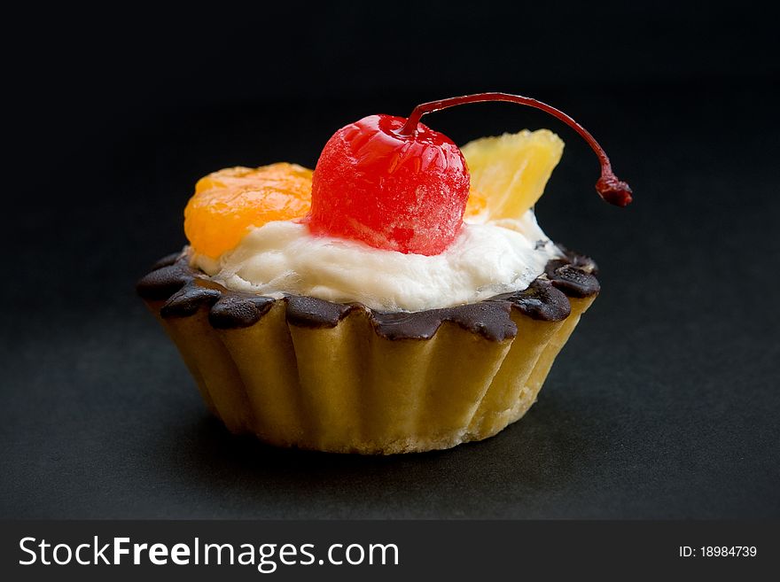 Chocolate covered baking with fruits - cherry, orange and grapefruit. Chocolate covered baking with fruits - cherry, orange and grapefruit