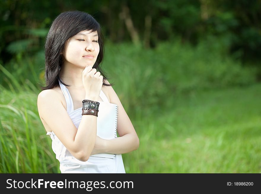 Portrait of a Beautiful Asian Chinese/Japanese girl laughing outdoors. Portrait of a Beautiful Asian Chinese/Japanese girl laughing outdoors