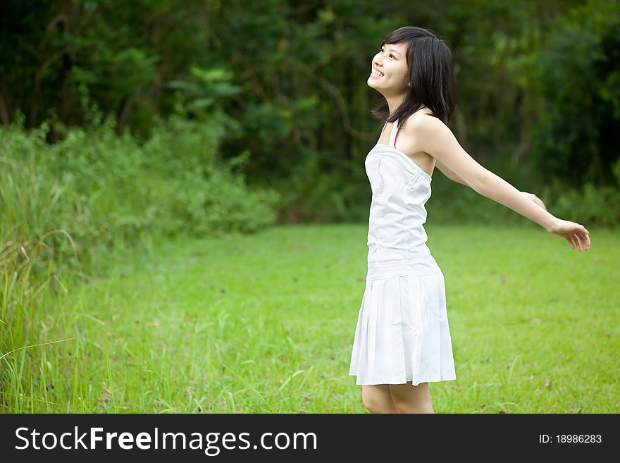 Beautiful Asian girl laughing outdoors