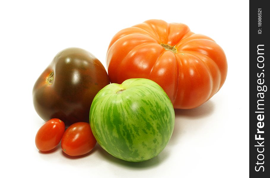 Variety of unusual tomatoes isolated on white. Variety of unusual tomatoes isolated on white.