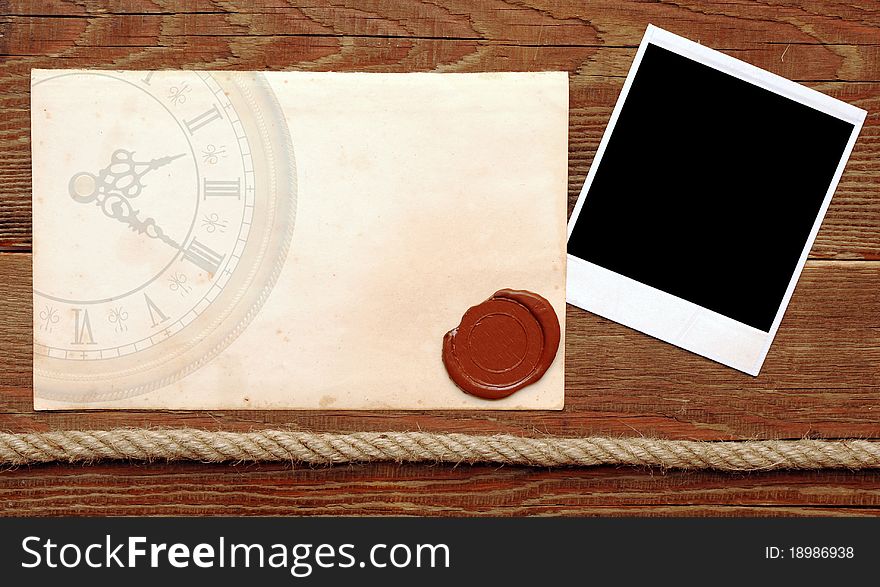 Old paper with a wax seal on a wood background