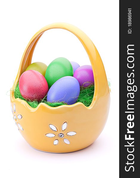 Basket full of Easter eggs isolated on white. Basket full of Easter eggs isolated on white