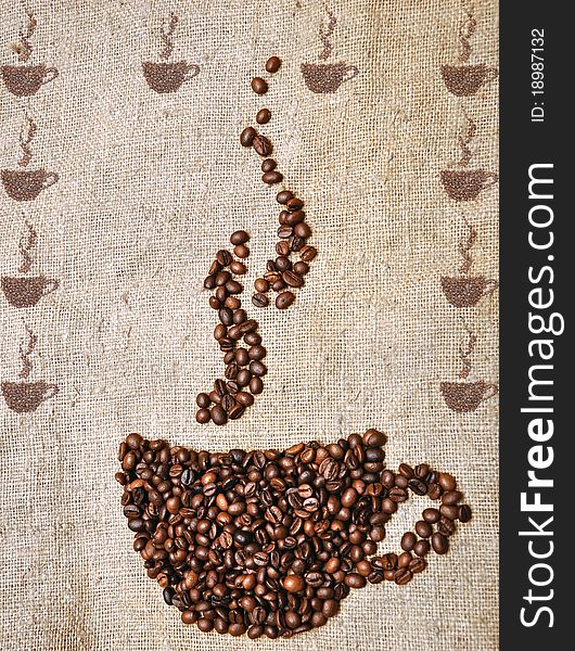 Coffee cup made of beans on sack background. Coffee cup made of beans on sack background