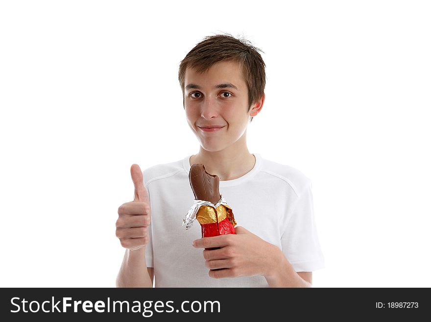 Boy gives the thumbs up. He is holding a bunny chocolate. Boy gives the thumbs up. He is holding a bunny chocolate