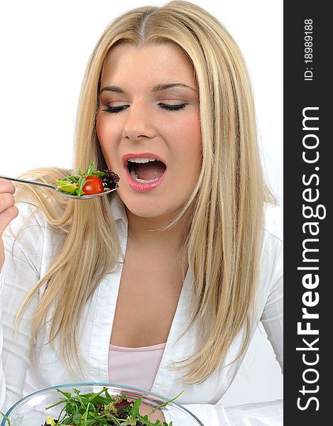 Pretty woman eating green vegetable salad