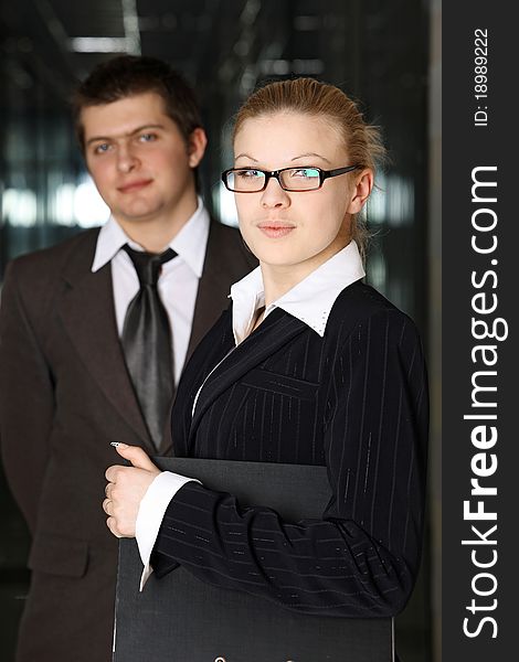 Confident businessman and businesswoman with folder. Confident businessman and businesswoman with folder