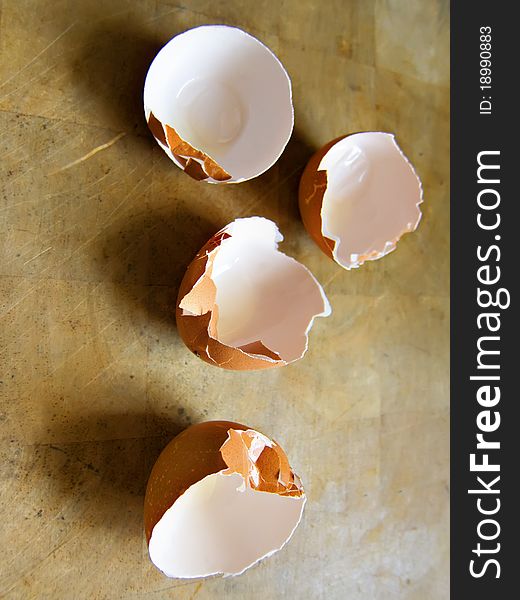 Broken eggs on a wooden surface