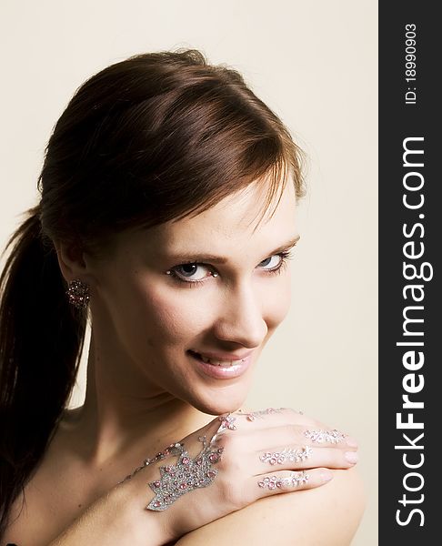 Young woman portrait with rhinestones on hands