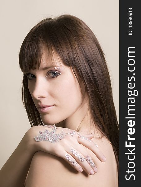 Young woman portrait with rhinestones on hands