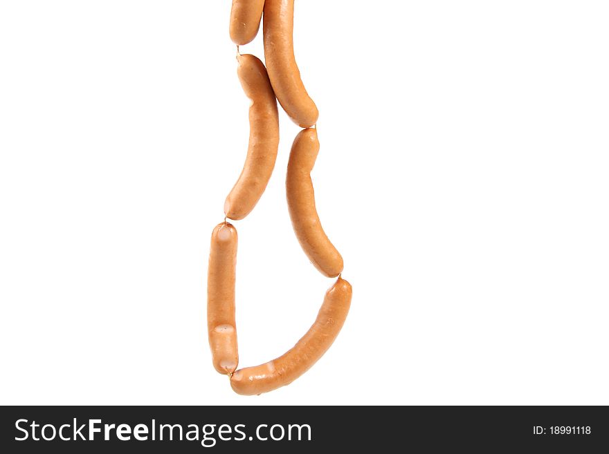 Bunch Of Sausages Hanging Over White