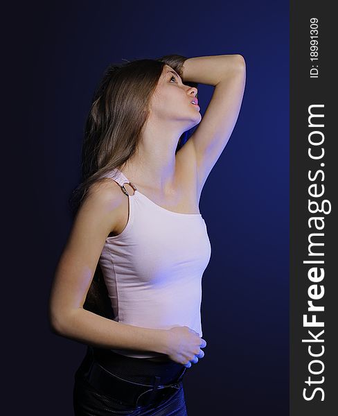 The beautiful young sexual woman on a dark background