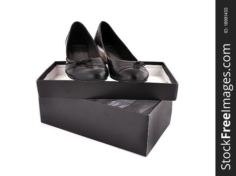 Black ladies shoes and box on a white background
