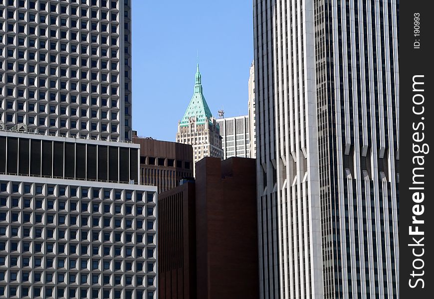 Small skyscraper appears between two larger skyscrapers. Small skyscraper appears between two larger skyscrapers