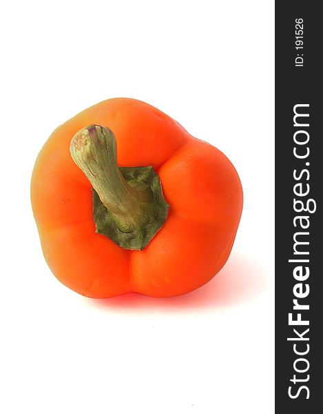 A fresh orange bell pepper over white