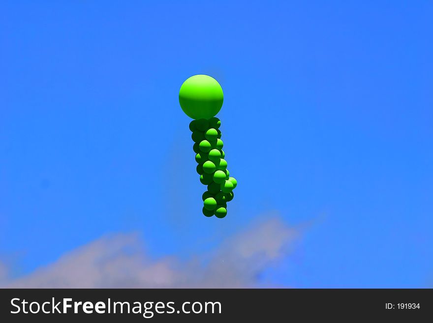 Green balloons against bright blue sky. Green balloons against bright blue sky