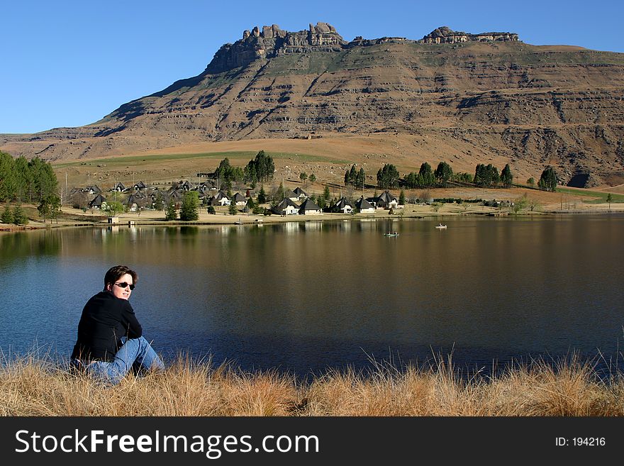 Woman looking at landscape of mountain and holiday lodge. Woman looking at landscape of mountain and holiday lodge