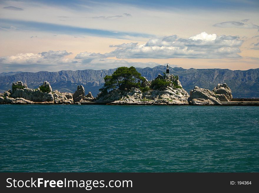 Statue of the Madonna on background of water, sky and mountains. Statue of the Madonna on background of water, sky and mountains