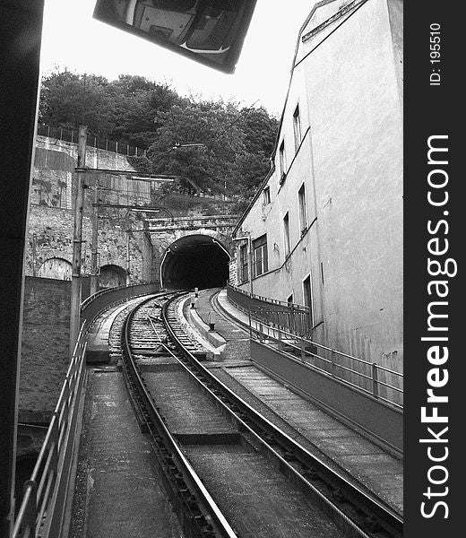 One way train going through the mountain in Lyon - black and white picture with grain filter added giving a dramatic look. One way train going through the mountain in Lyon - black and white picture with grain filter added giving a dramatic look