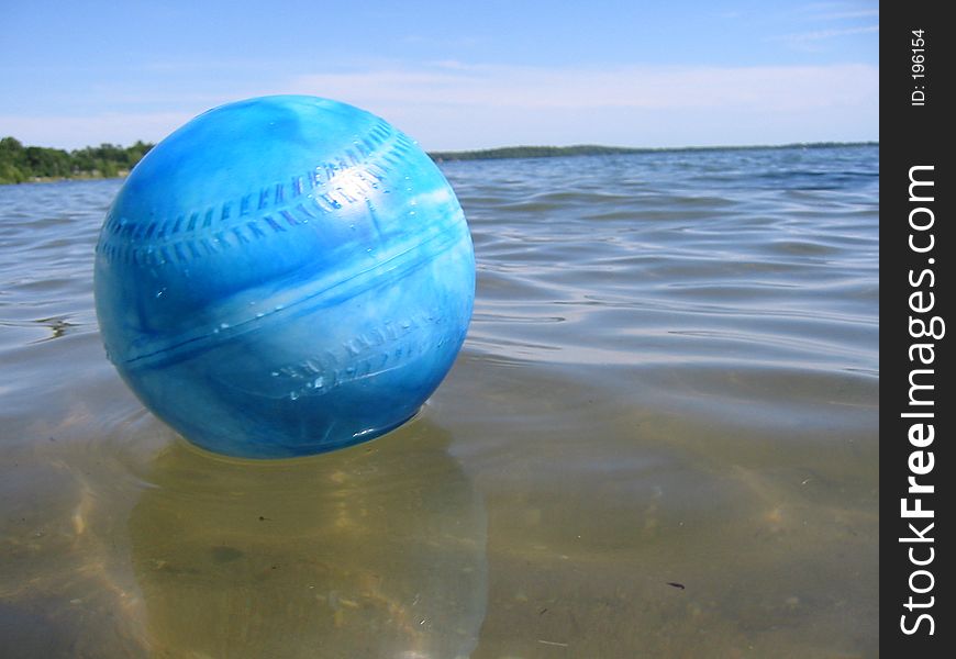 Blue ball floating in lake. Blue ball floating in lake