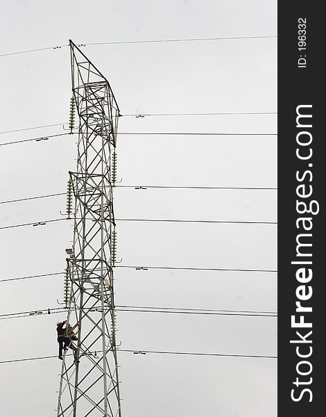 Workers climbing on power pylon