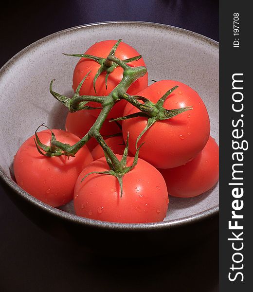 Bowl of red tomatoes on vine. Bowl of red tomatoes on vine