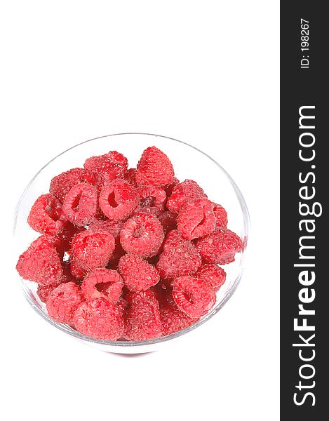 Fresh red raspberries in a clear bowl on a white background