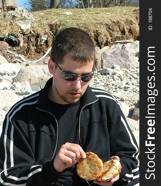 Young man eating in the nature