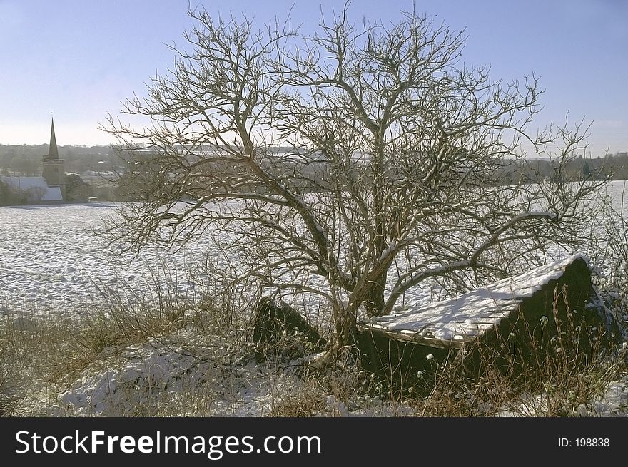 A hut in the snow with church in background. A hut in the snow with church in background.