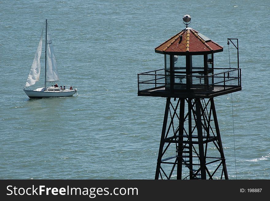 Tower and sailboat in ocean