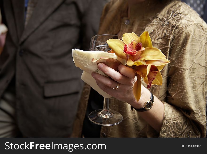A woman holding her drink with flowers. A woman holding her drink with flowers