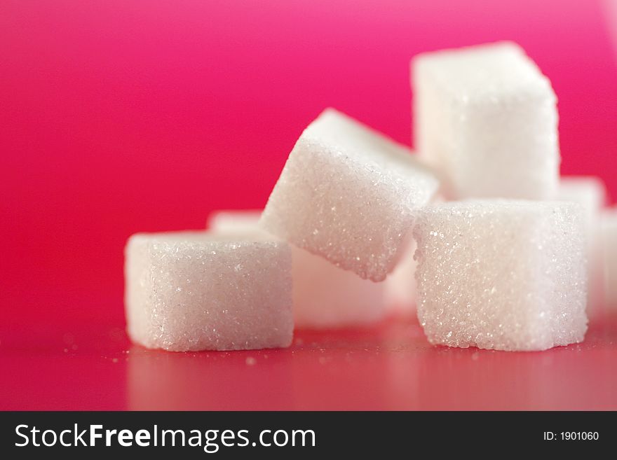 Sugarcubes infront of a pink background