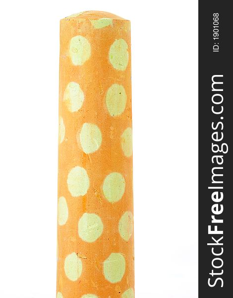 Single piece of yellow polka dot chalk. Single piece of yellow polka dot chalk