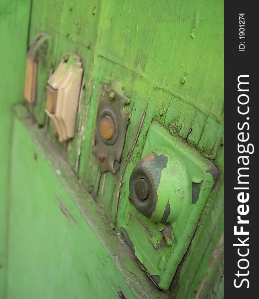 Various shapped painted green doorbells.