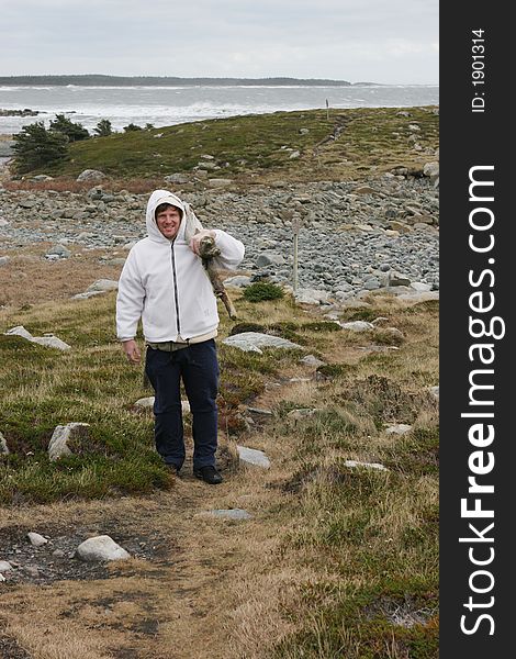 Happy man collecting drift wood from the beach in winter. Happy man collecting drift wood from the beach in winter