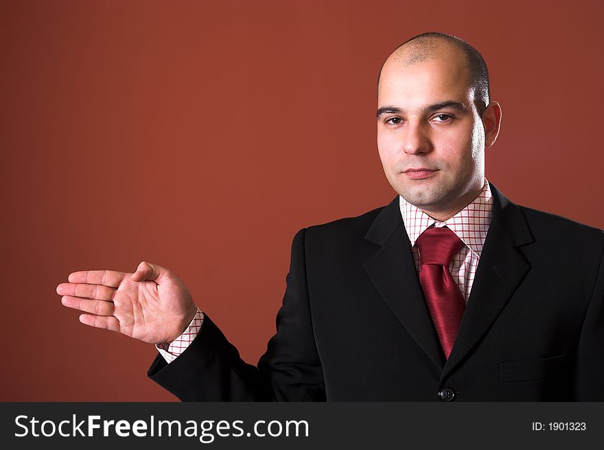 A Businessman pointing on red background