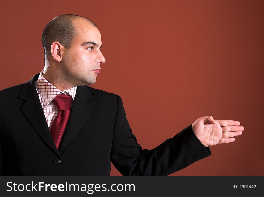 A Businessman pointing on red background