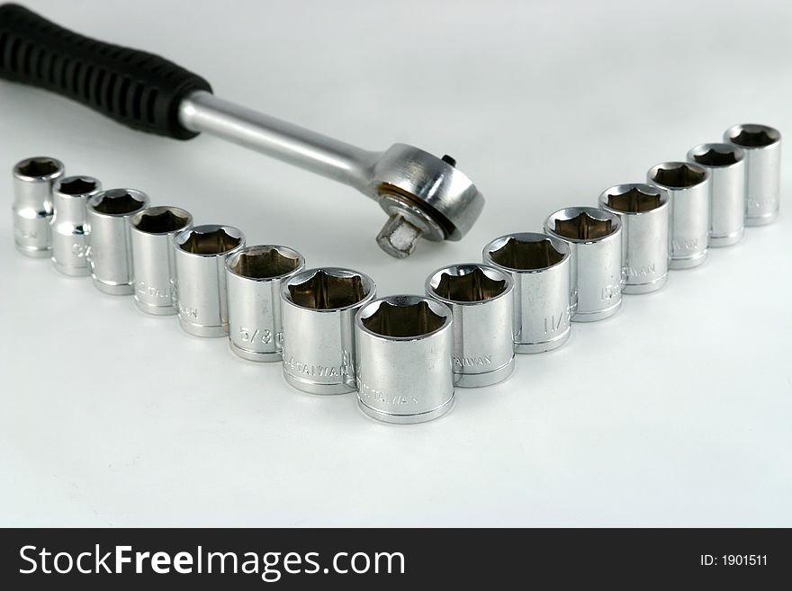 A socket wrench with various size sockets arranged in a v-pattern. A socket wrench with various size sockets arranged in a v-pattern.