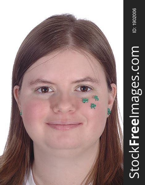 A smiling woman with green shamrocks on her cheek. A smiling woman with green shamrocks on her cheek.