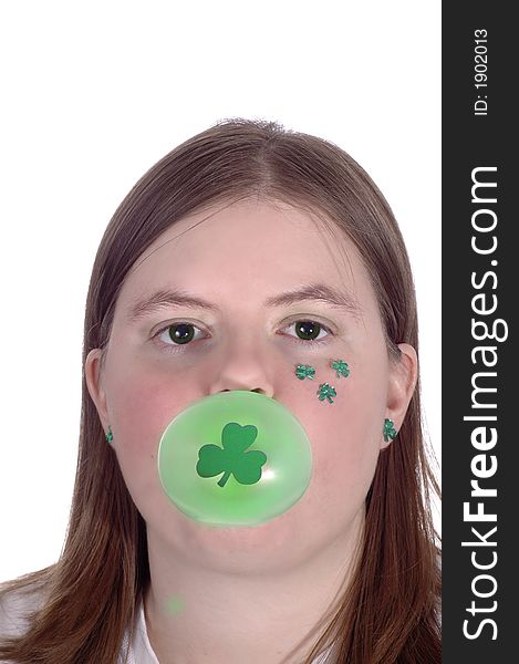 A woman with shamrocks on her cheek chewing green bubble gum. White Background. A woman with shamrocks on her cheek chewing green bubble gum. White Background.