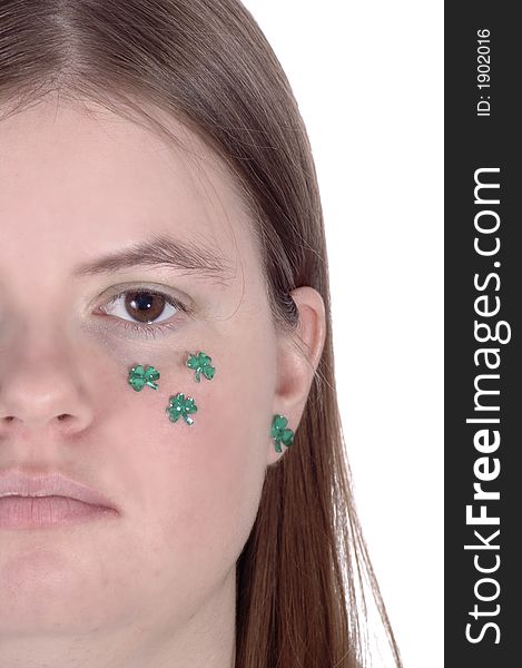 A smiling woman with green shamrocks on her cheek. A smiling woman with green shamrocks on her cheek.