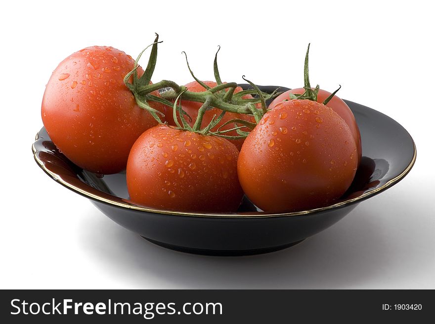 Fresh tomatoes arranged in a black bowl. Fresh tomatoes arranged in a black bowl