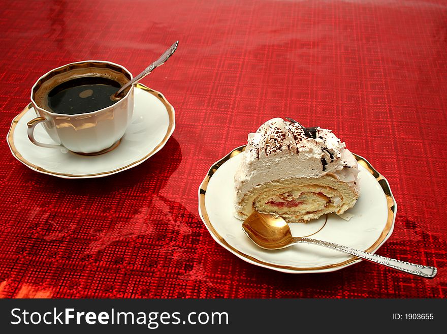 Cup of coffee with the spoon and a slice of a pie on a red background