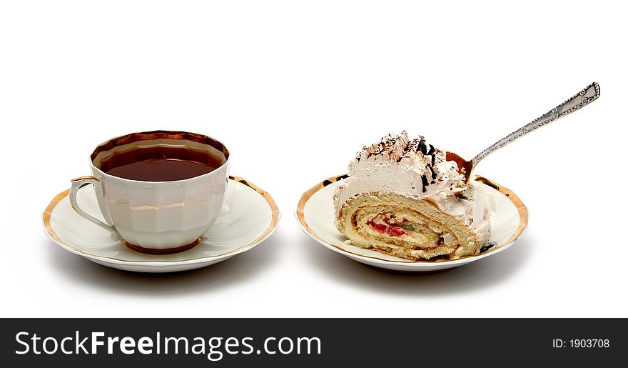 Cup of tea with the spoon and slice of pie on white