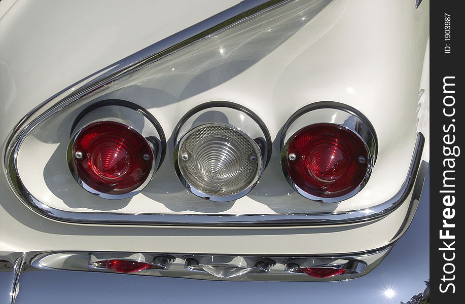 Close-up of rear-light cluster of white car from the 1960s. Close-up of rear-light cluster of white car from the 1960s