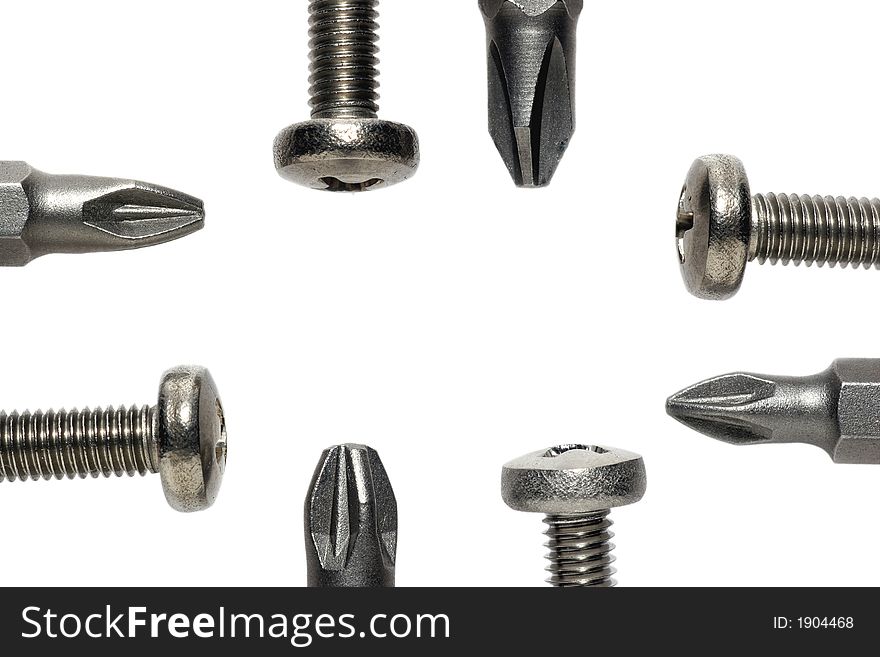 Macro picture of Phillips screws (M4) with screwdriver bits. Macro picture of Phillips screws (M4) with screwdriver bits.