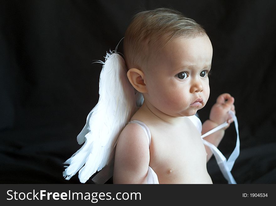 Image of baby wearing angel wings. Image of baby wearing angel wings