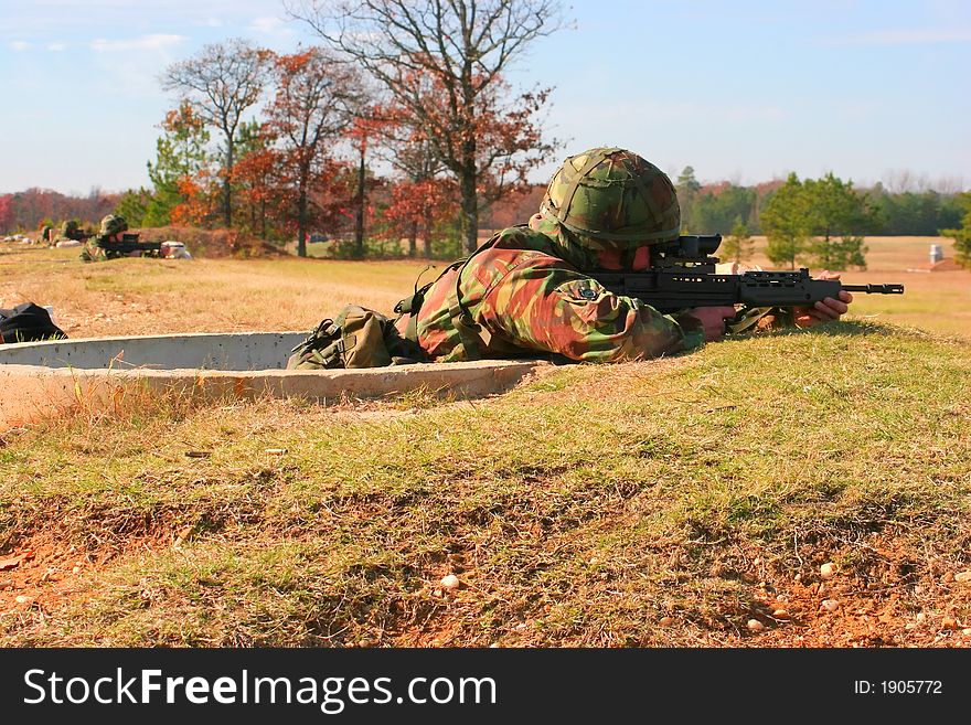 Soldiers firing SA80 rifles on the range