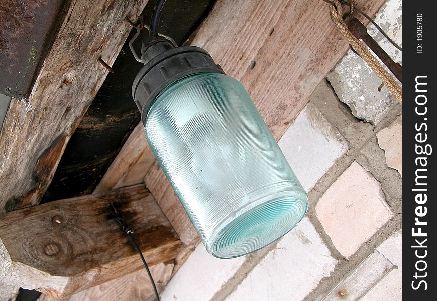 Street lamp hanging on the wall, rural scenic