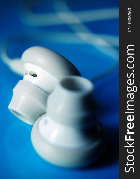 White headphones on a blue background.