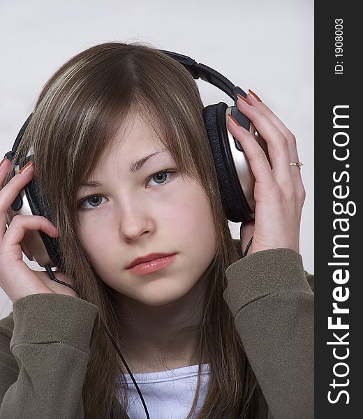 Portrait of the young beautiful glamour woman with headphones. Portrait of the young beautiful glamour woman with headphones